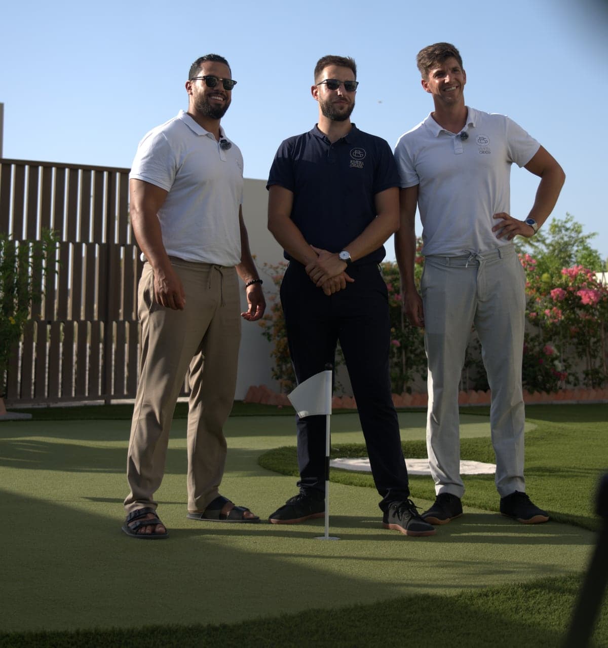 The three Riviera Grass founders standing on a private putting green in Dubai